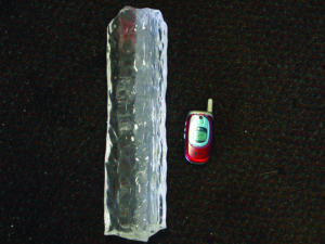 A piece of ice wrapped around a power line is compared to a cell phone. 