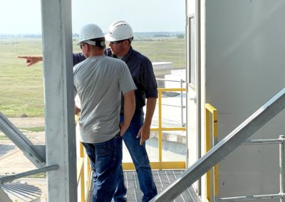 Mitch Feldman, KAAPA Ethanol Ravenna Plant Manager, (right) discusses the facility with Dawson PPD Lineman Jerry Folck from the top of its largest grain bin.