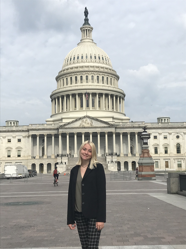 Kylee Edwards stands in front of the U.S. Capitol building. Kylee was chosen to represent Dawson Public Power District at the 2022 Nebraska Rural Electric Association Youth Tour.