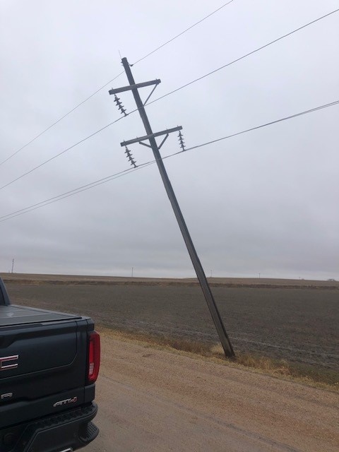 Broken sub-transmission line pole from a storm